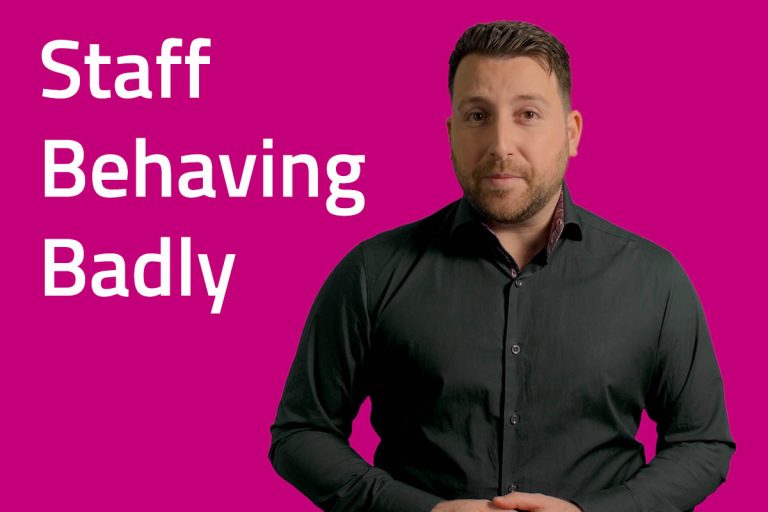 Staff Behaving Badly - A presenter talking in front of a pink background.
