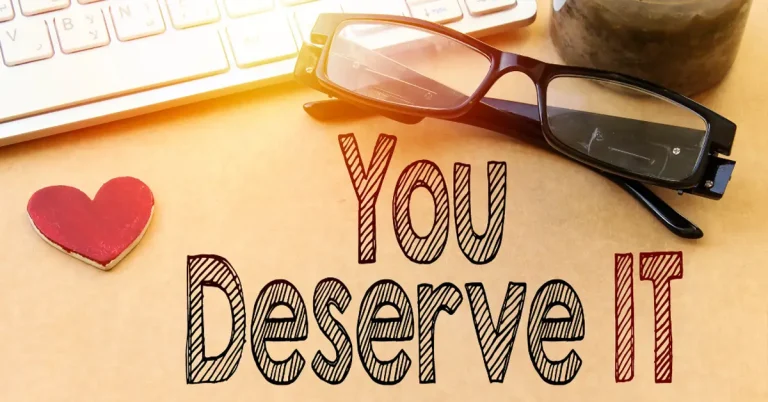 A pair of glasses and a computer keyboard with the words 'You Deserve It'.